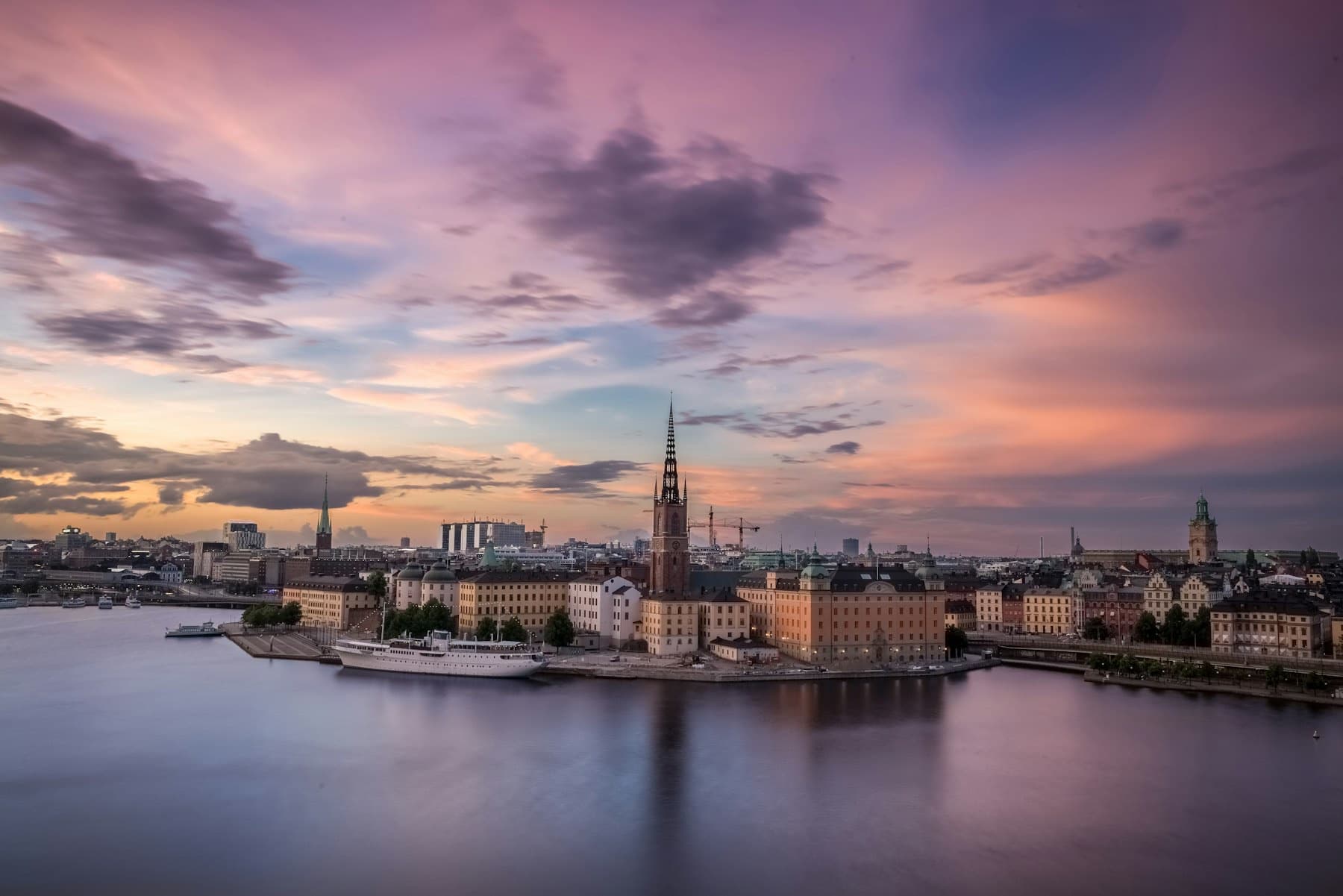 Stockholm waterfront with historic buildings and a church spire, in black and white